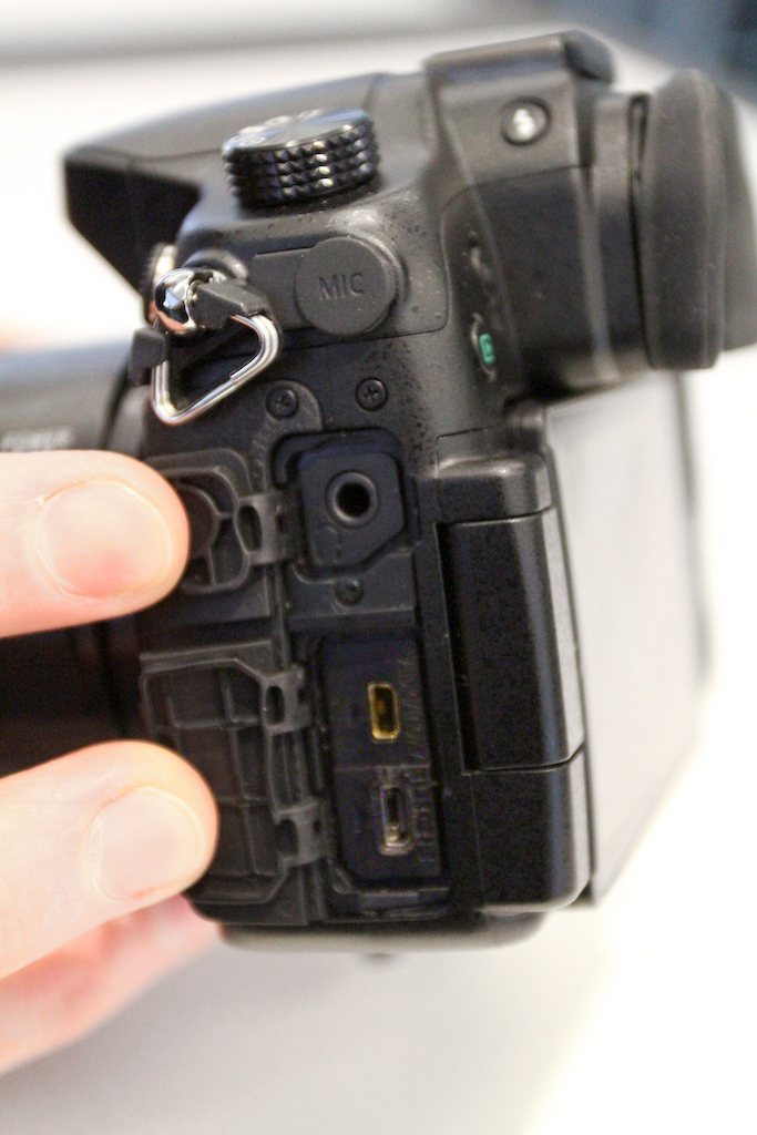 Here's a clue. The headphone socket is at top, like a GH3. But the gold AV OUT/DIGITAL socket is now above the HDMI, in reverse order compared to the GH3. And the HDMI socket is micro, smaller than the mini found in the GH3.