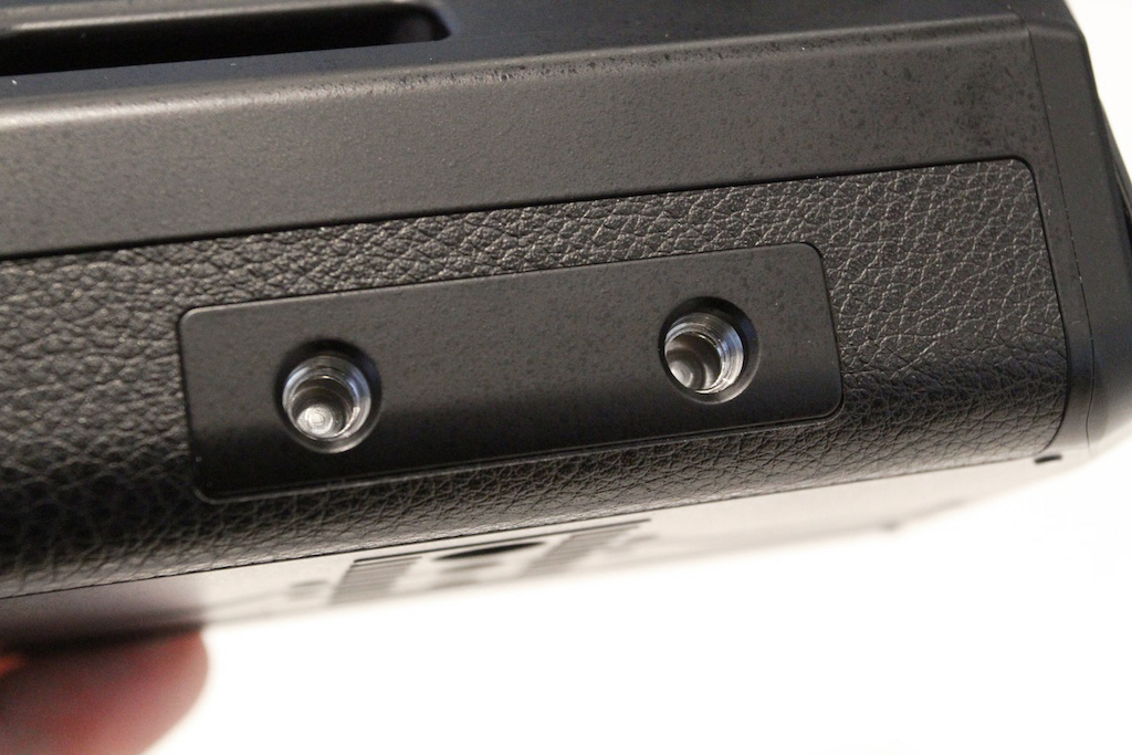 Intriguing are these dual 1/4-20 holes at the bottom front of the DMW-YAGH, likely for some sort of rod-based lens support, on which Panasonic hinted third parties were already working.